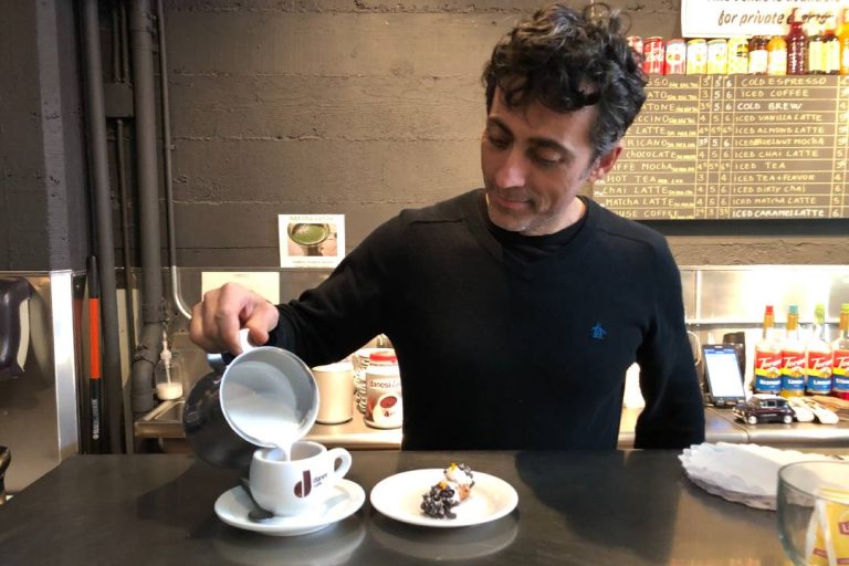 A photo of someone pouring a coffee.