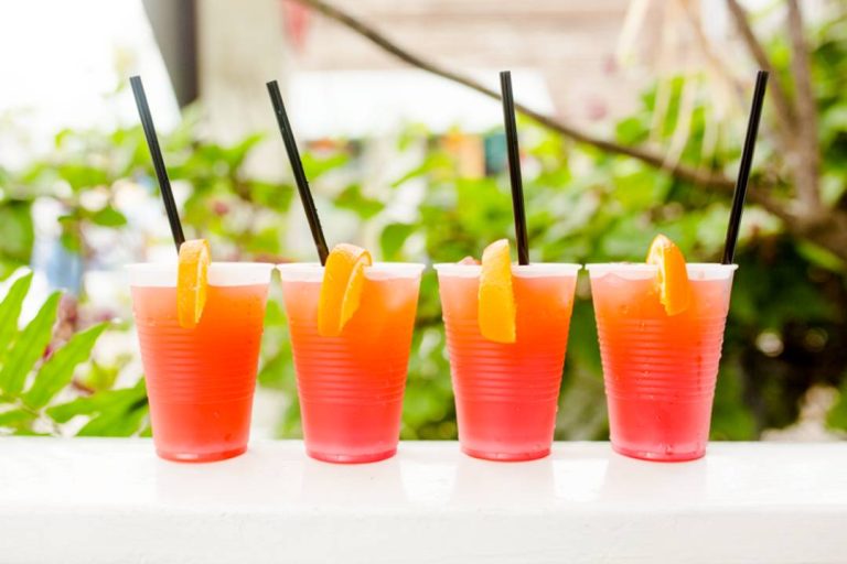 A photo of four glasses of Sex on the Beach.